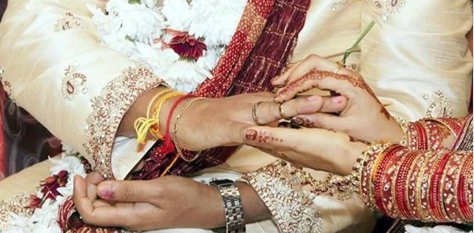 bride sister kissing groom on stage 