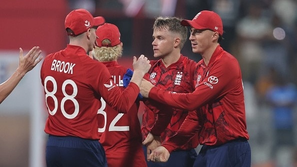 England's Sam Curran (2nd from R) celebrates with his teammates in this frame