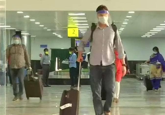 फेस शील्ड में यात्री, पीपीई किट में स्टाफ, कोरोना काल में ऐसे हो रही हवाई यात्रा