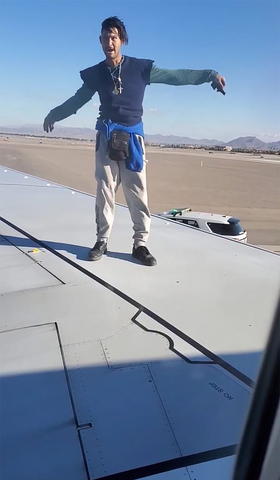 man climbs plane wing