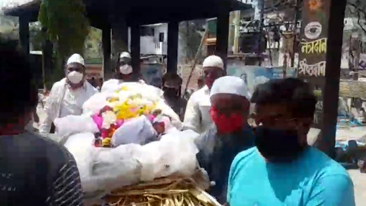 Muslims engaged in funeral