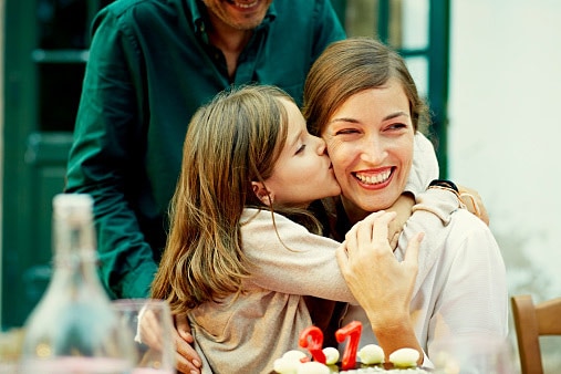 woman kiss her daughter