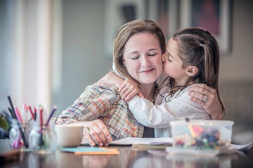 woman kiss her daughter