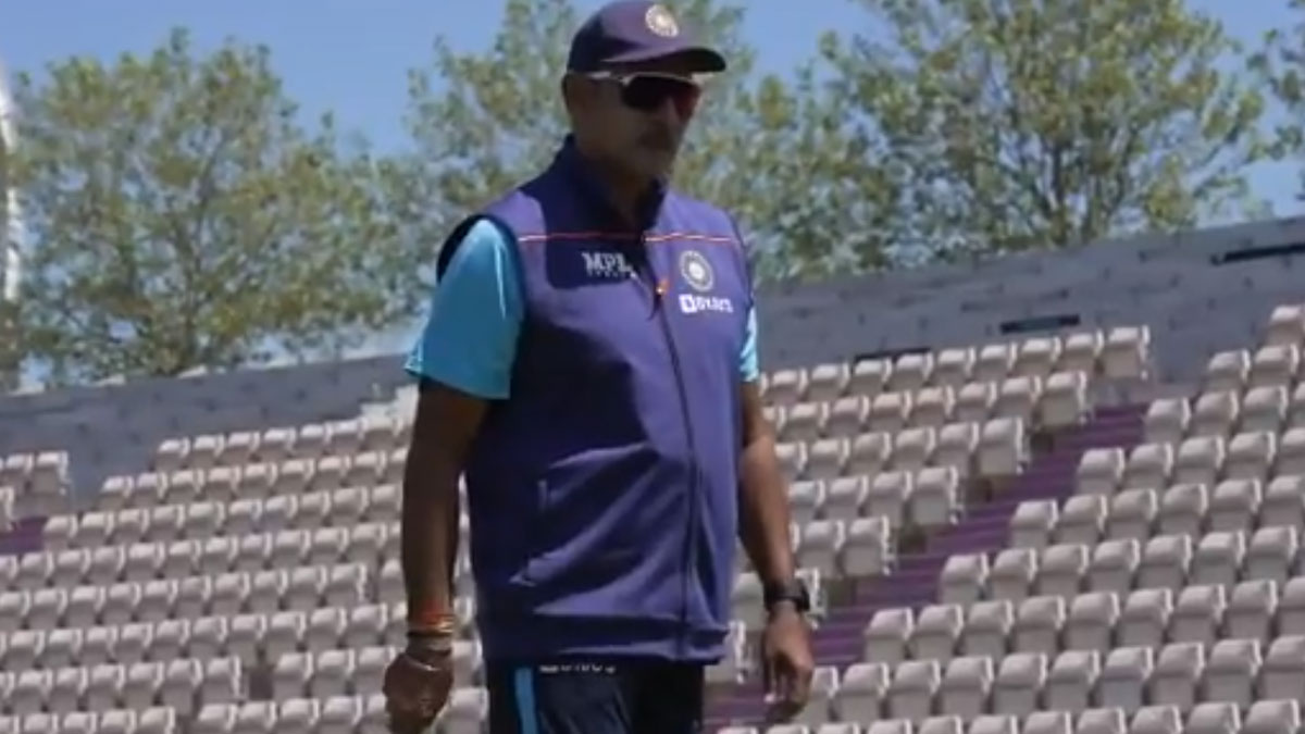 Ravi Shastri gets playful with a dog during practice sessions