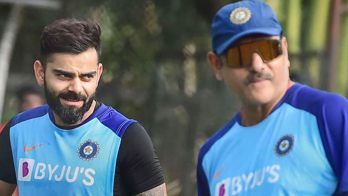 Ravi Shastri gets playful with a dog during practice sessions