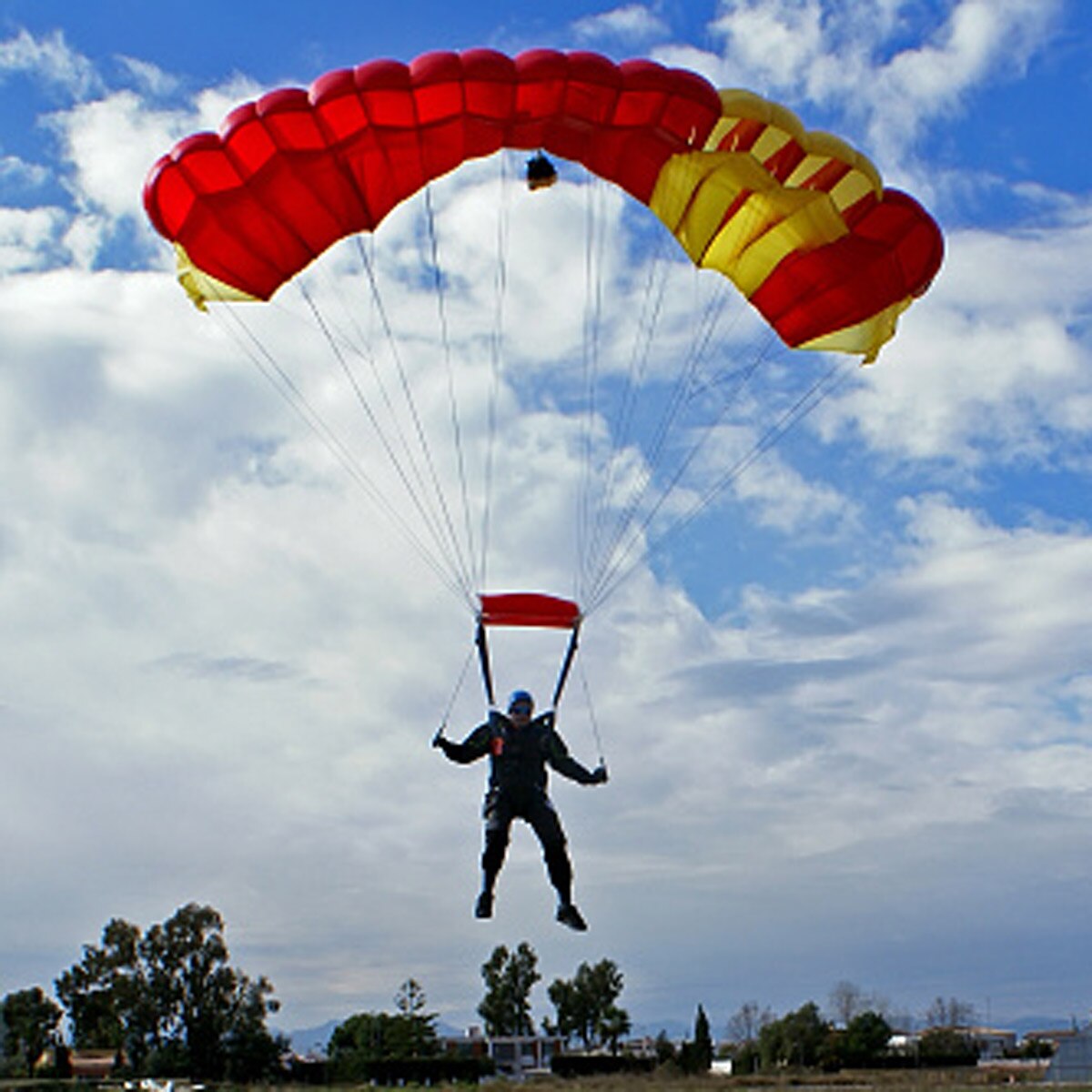 Parachuter plunges through roof