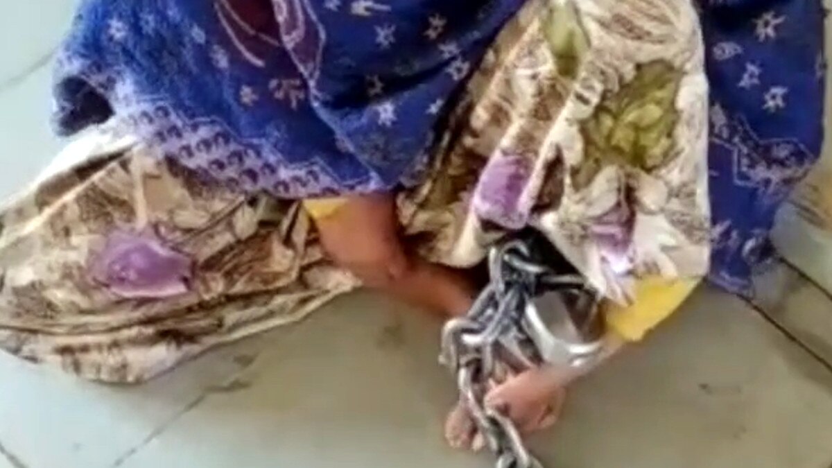 woman tied to chain