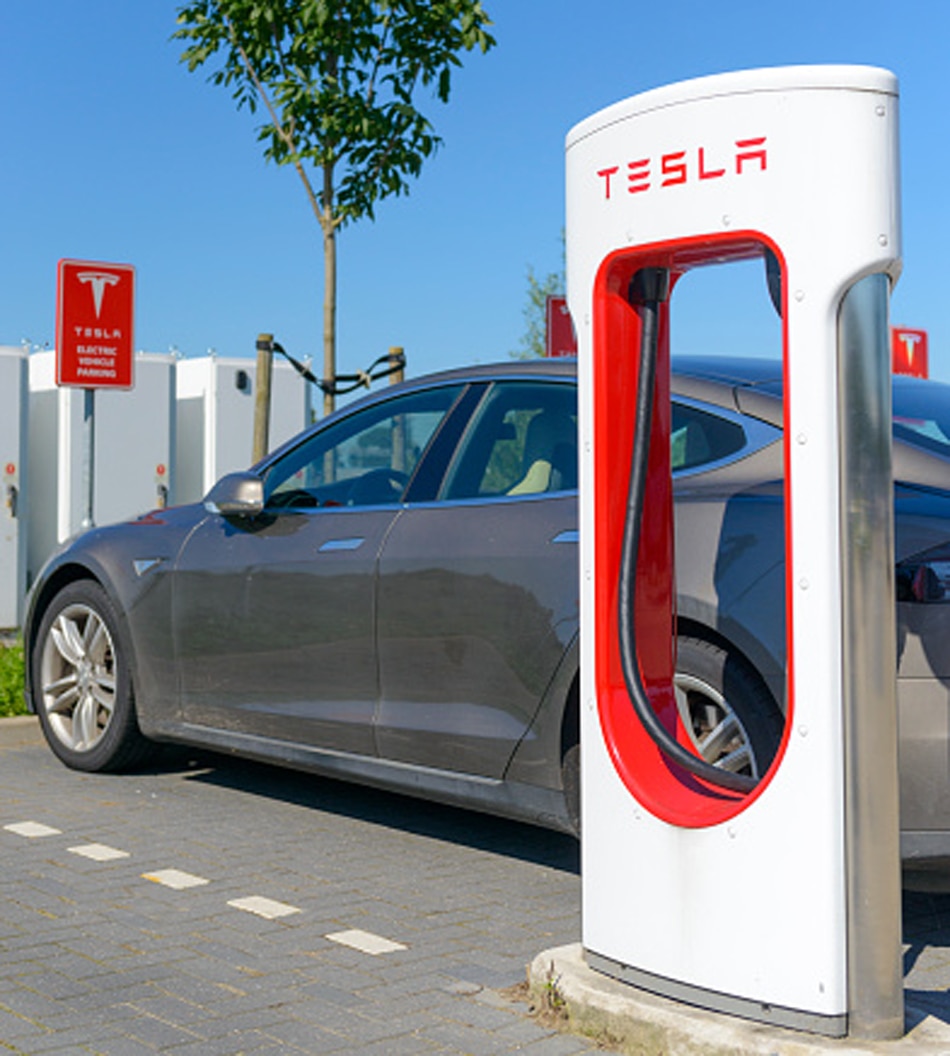 tesla car burned house 