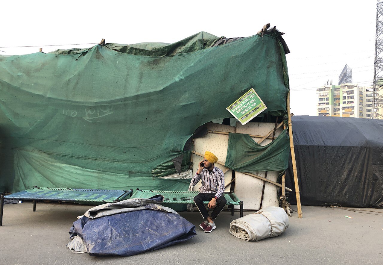 किसान आंदोलन समाप्ति के बाद सिख युवक सामान समेटने के बाद फोन पर बात करता हुआ