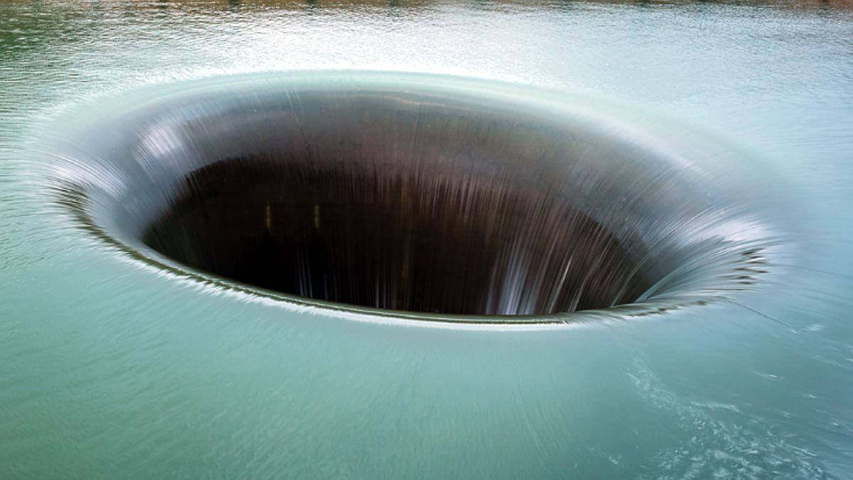 Bizarre whirlpool glory hole in water is true center of earth 