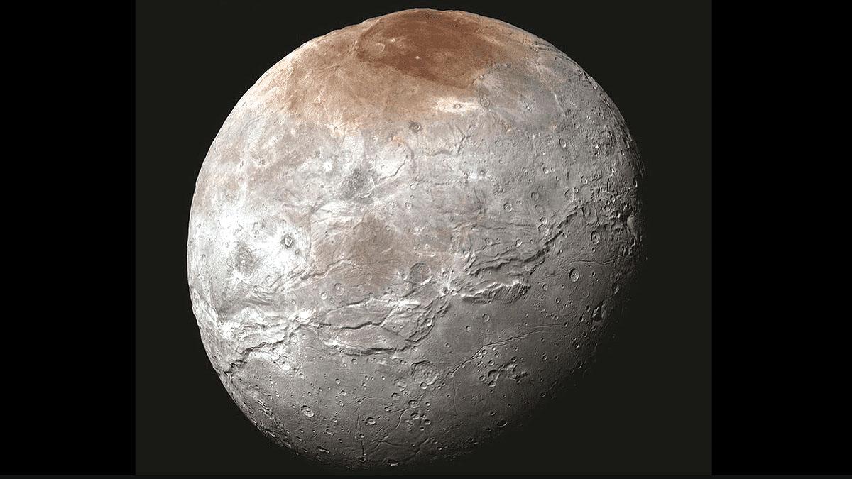 why pluto moon charon wears a red cap 