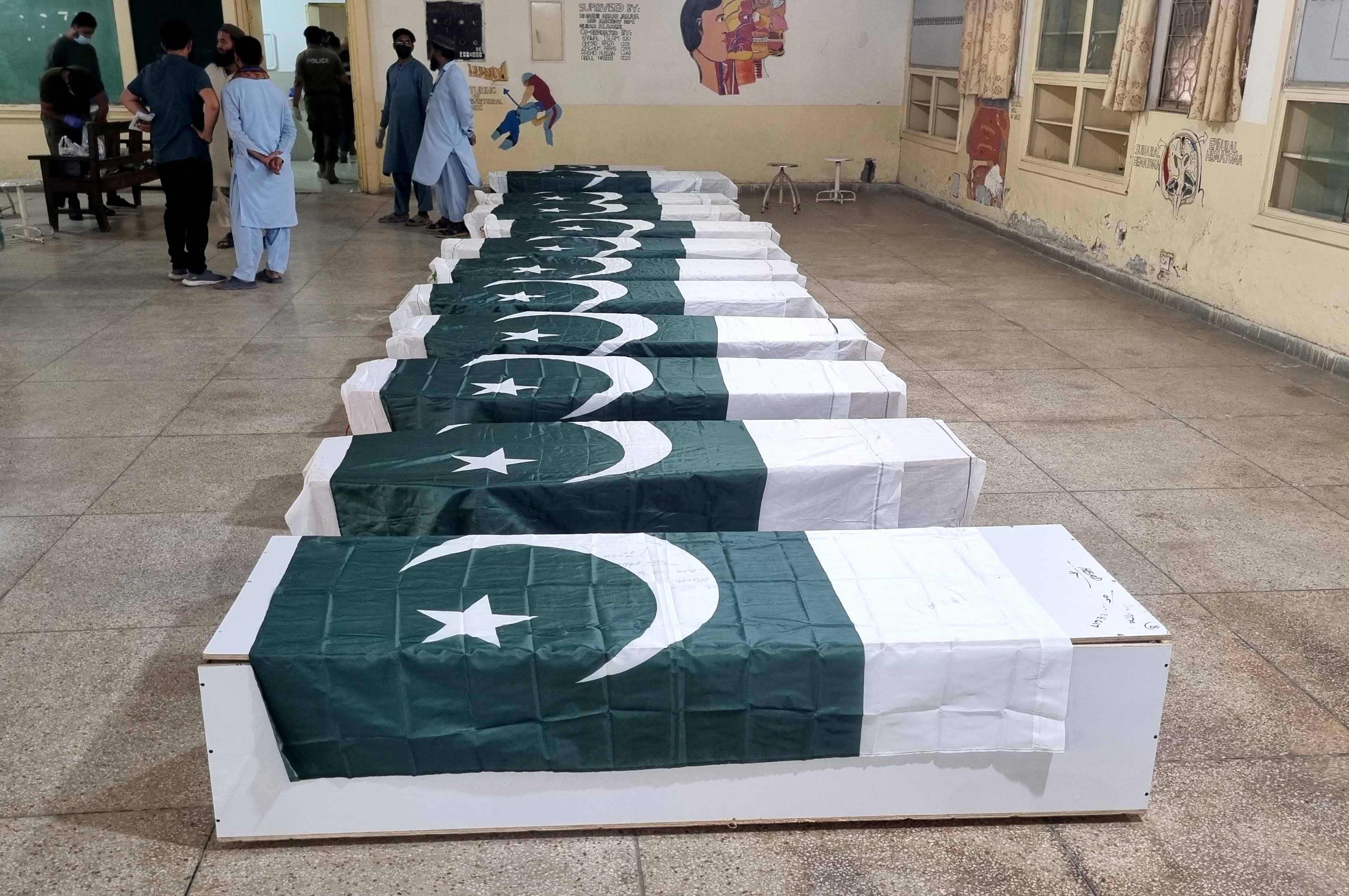 Coffins draped in Pakistani flags
