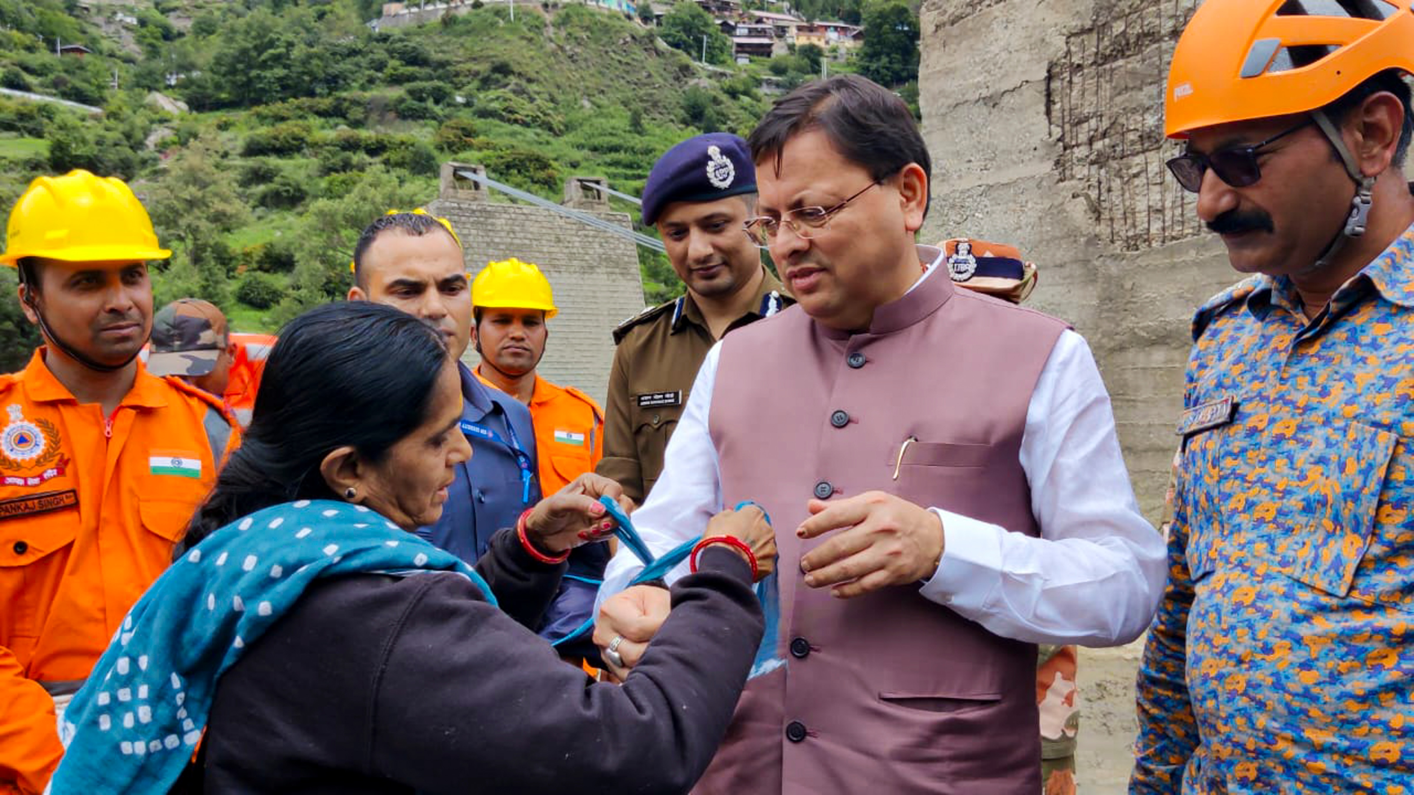 Woman ties a Rakhi on Uttarakhand CM Pushkar Singh Dhami