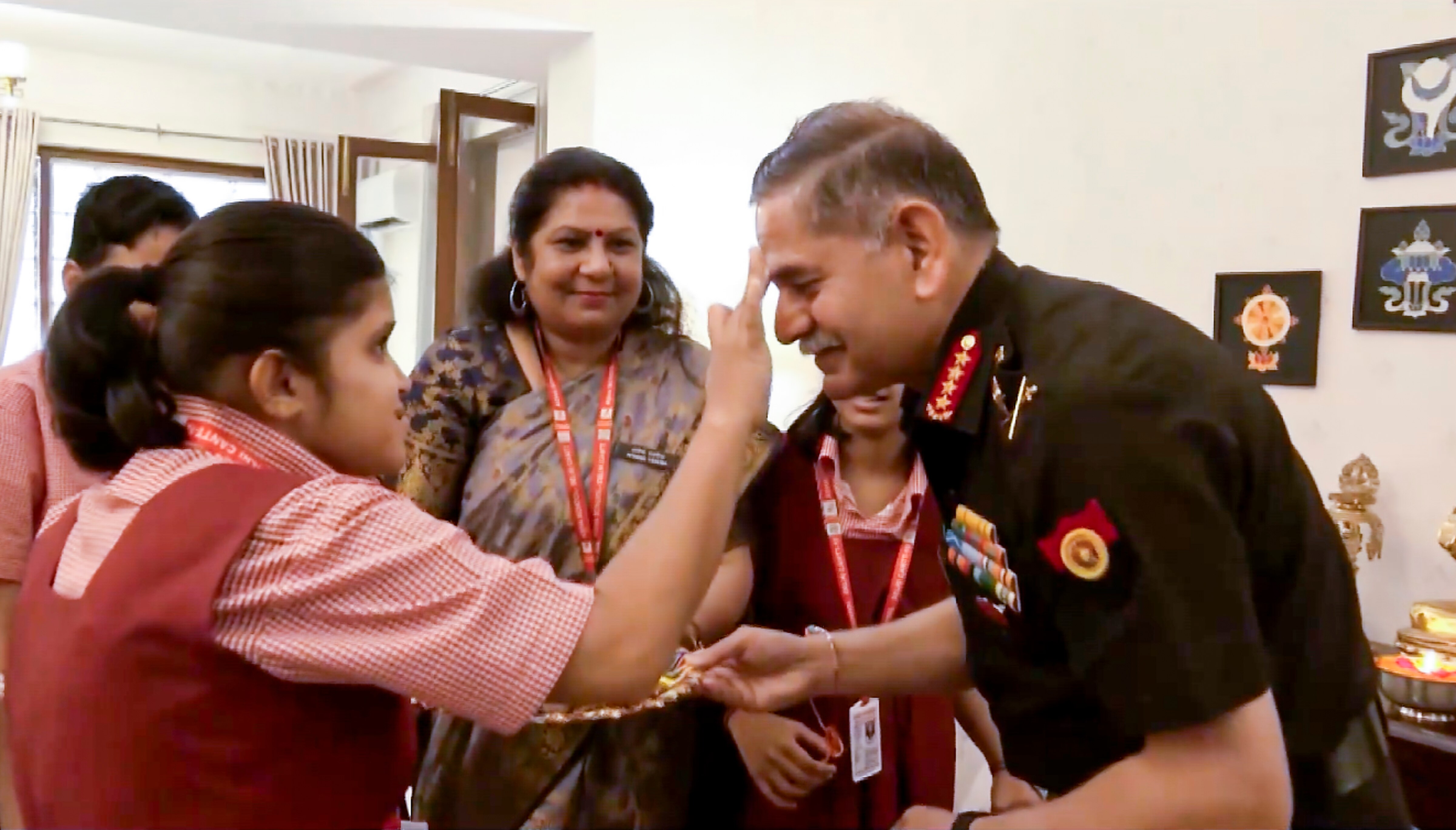  girl tying a rakhi to Army Chief General Upendra Dwivedi