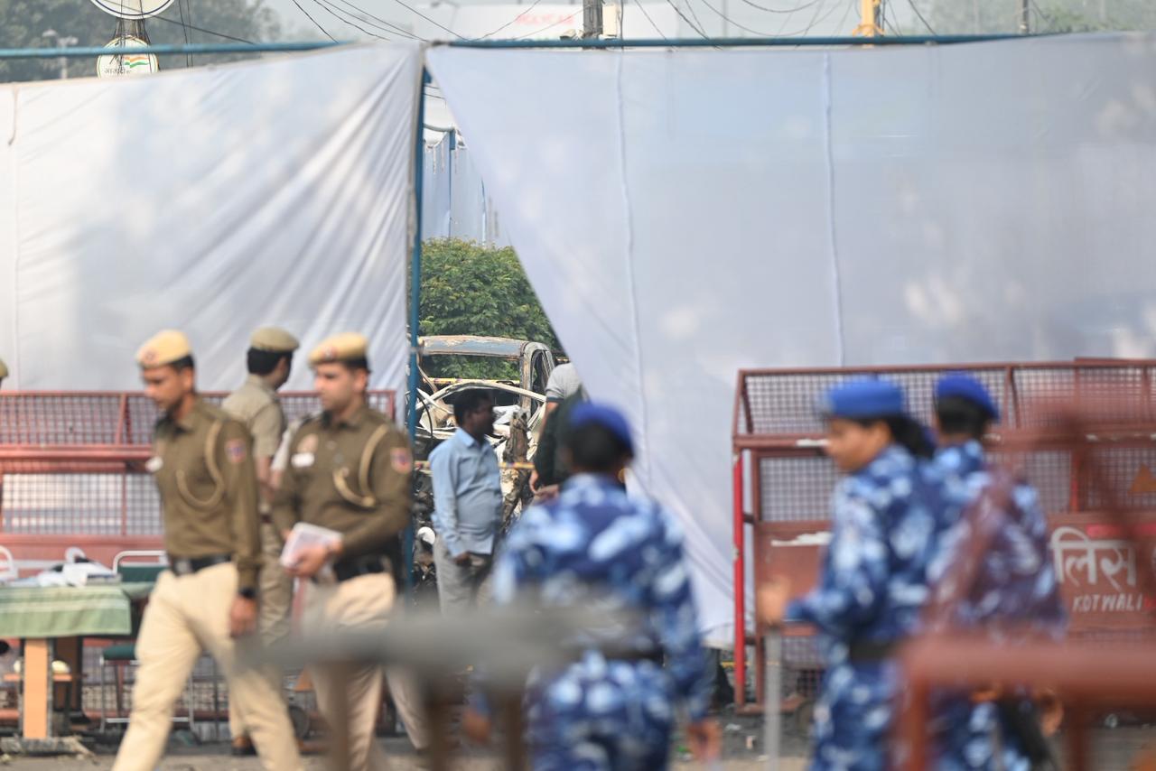 Forensic experts investigate at the blast site following an explosion near the Red Fort