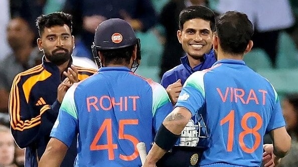 Rohit Sharma and Virat Kohli are congratulated by India's captain Shubman Gill (2R) in this frame