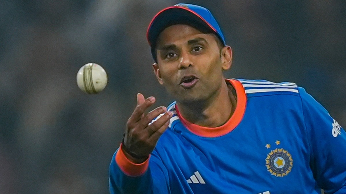  India's captain Suryakumar Yadav passes the ball during the second T20 International cricket match of a series between India and South Africa, at Maharaja Yadavindra Singh International Cricket Stadium