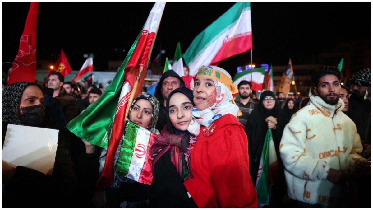 Iranians celebrate and wave flags after Trump announced a two-week ceasefire.