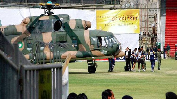 Sri Lankan officials and players prepare to board into a helicopter at Qadhafi stadium after the shooting.