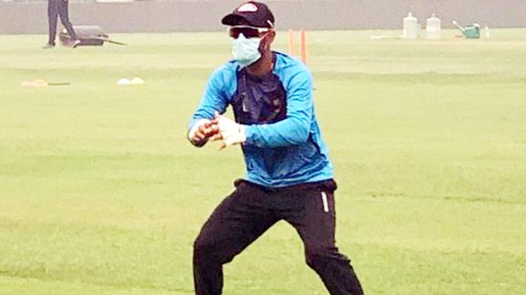 Bangladeshi batsman Liton Das practices while wearing a mask