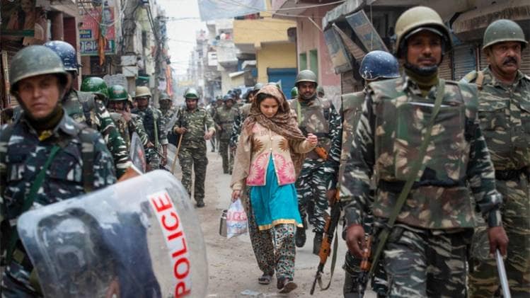 दिल्ली के हिंसा प्रभावित इलाके में तैनात पुलिस (फोटो-PTI)