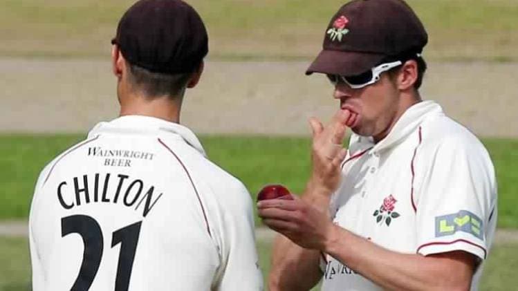 A cricket player shines the ball during an English county match (Getty)
