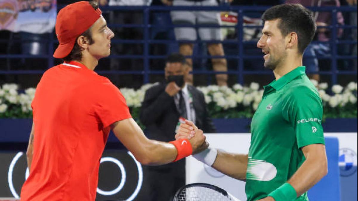 Lorenzo Musetti of Italy (L) greets Novak Djokovic. (Getty)