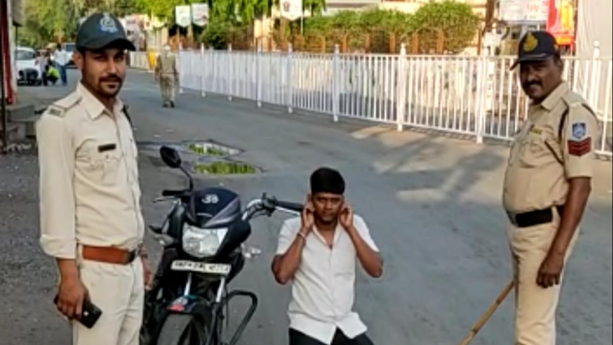 कान पकड़कर उठक-बैठक कराते पुलिसकर्मी