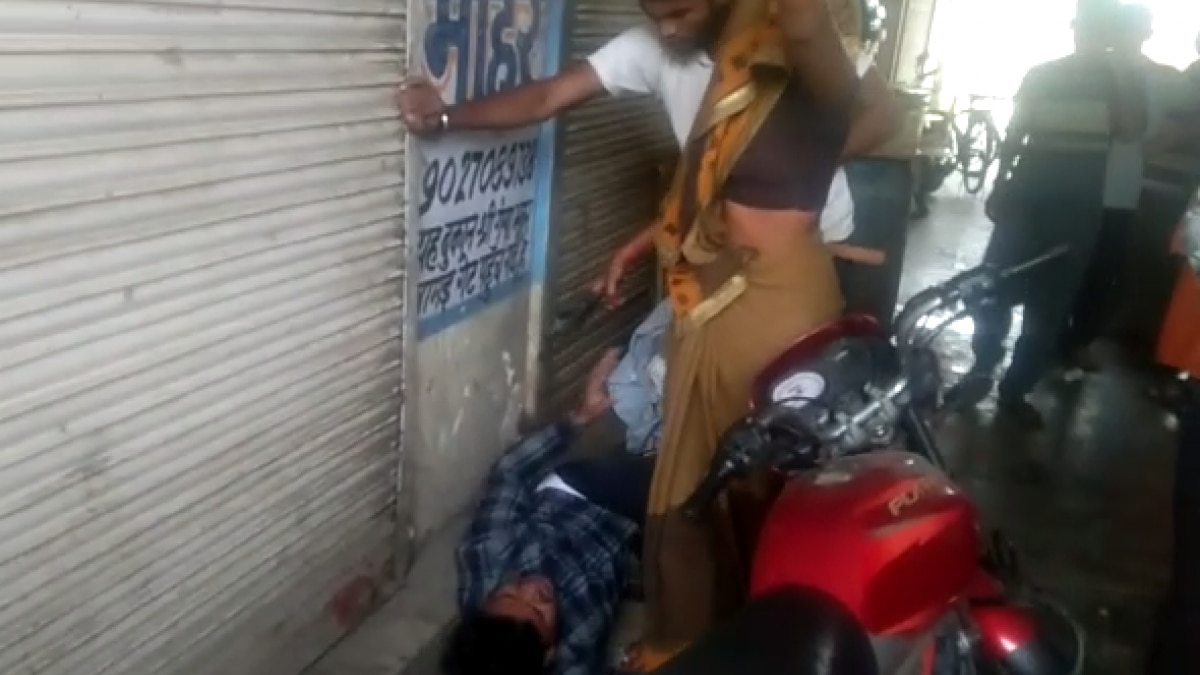 युवक को चप्पलों से पीटती महिला