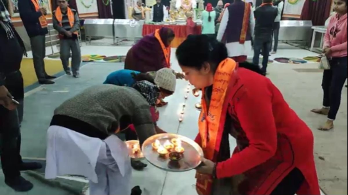मंदिर में दीप जलाते श्रद्धालु.