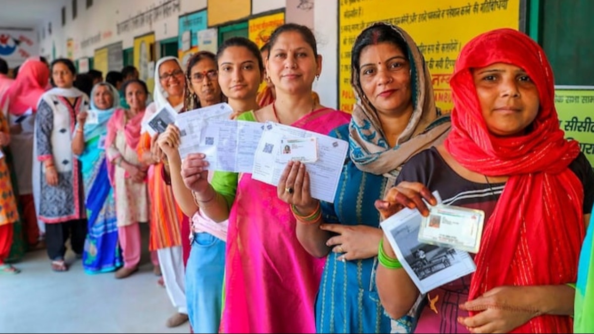 बुलंदशहर में लोकसभा चुनाव के दूसरे चरण के लिए वोट डालने का इंतजार कर रहीं महिला मतदाता. (PTI Photo)
