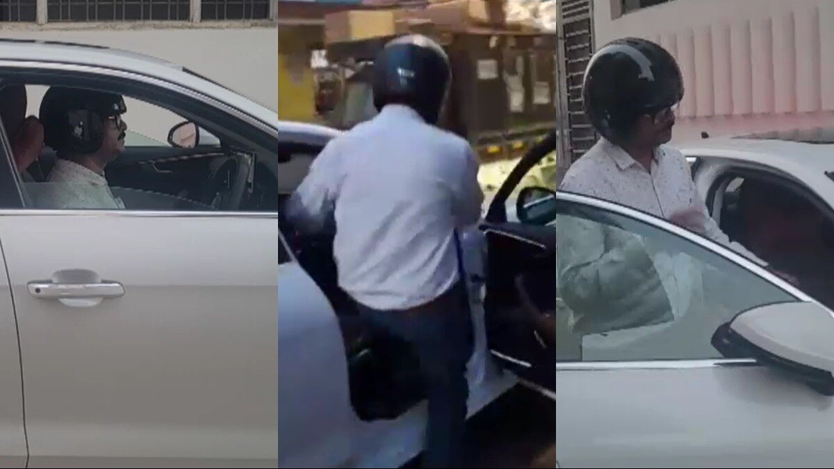 हेलमेट पहनकर कार चलाता शख्स