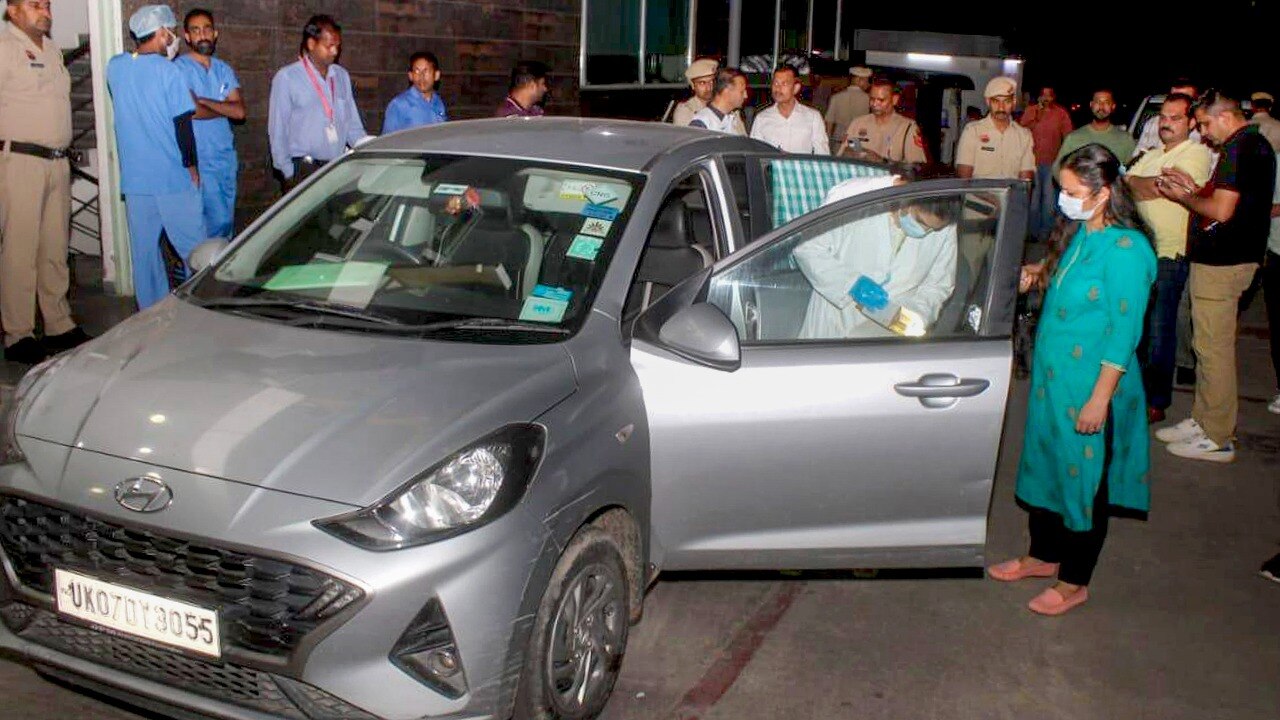 Police and forensic experts investigate after seven members of a family from Dehradun allegedly consumed poison and died in a car. (PTI photo)