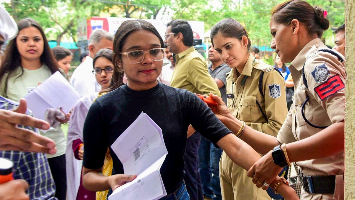 Candidates undergo security check as they arrive to appear for exam (PTI Photo)