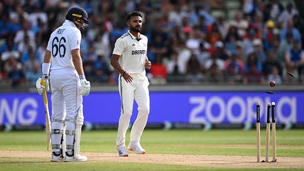 Akash Deep hits the stumps as England batsman Joe Root.