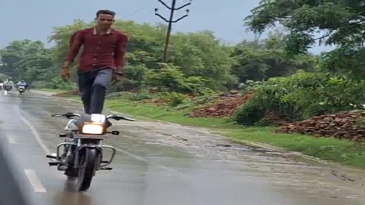 man standing on running bike