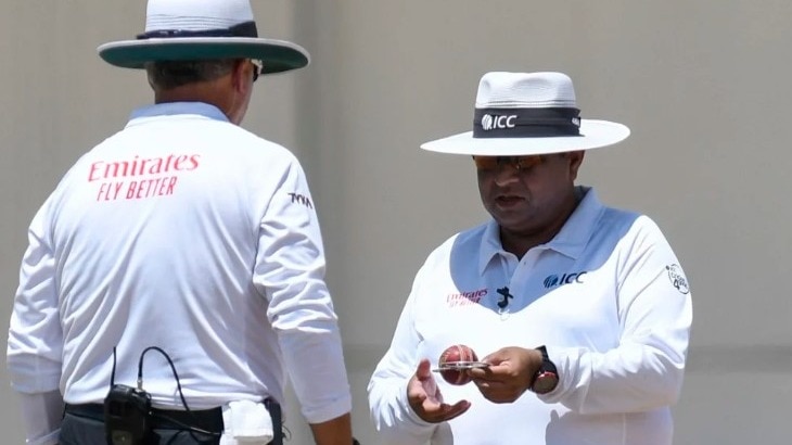 Umpire inspects the ball.jpg