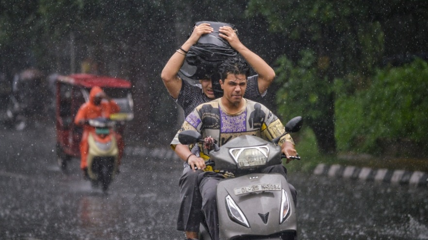 Commuters during rainfall, in New Delhi (PTI File Photo)