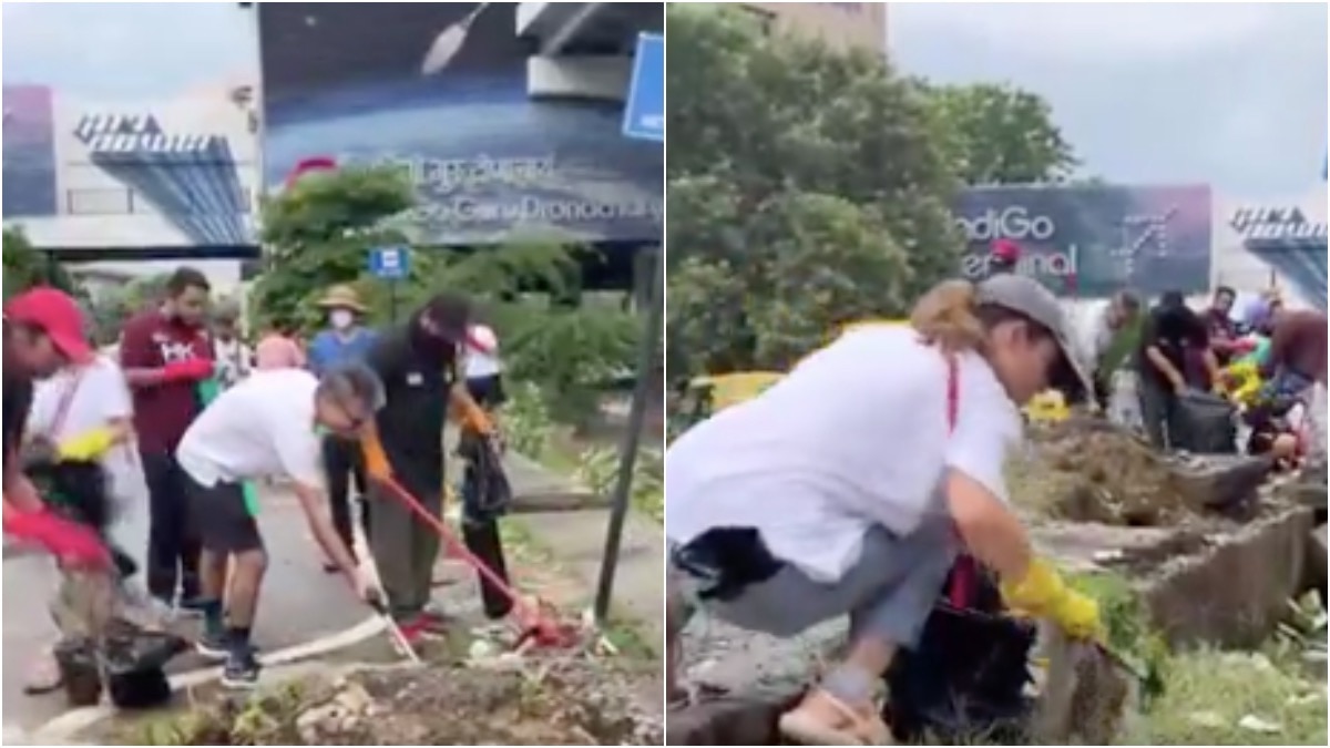 गुरुग्राम में सफाई करते दिखे विदेशी नागरिक (Photo:ANI)