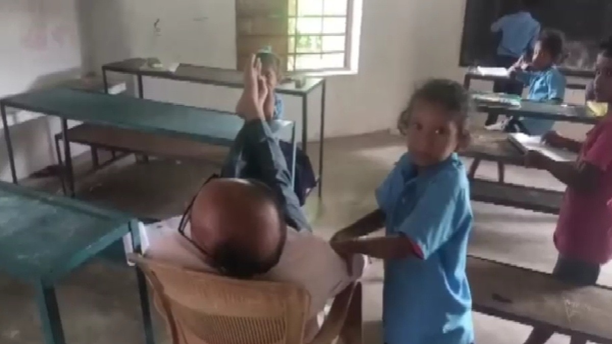 girl standing beside teacher