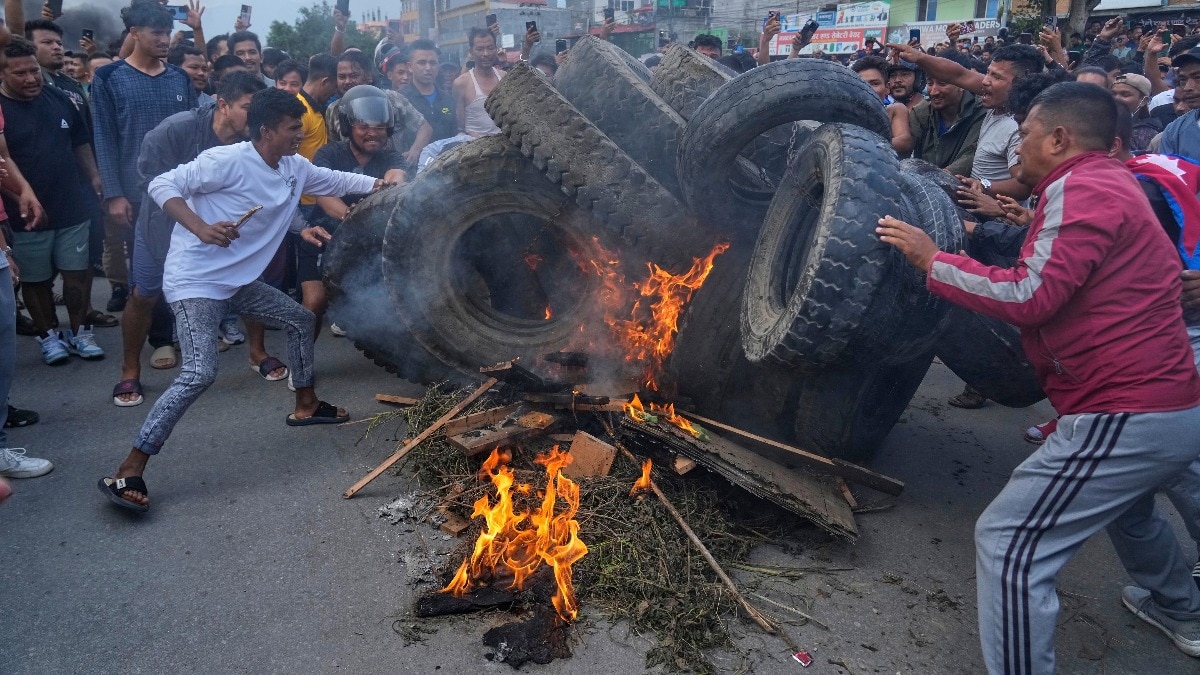 Protesters burn tires violating the curfew orders in Kathmandu, Nepal (Photo: AP)