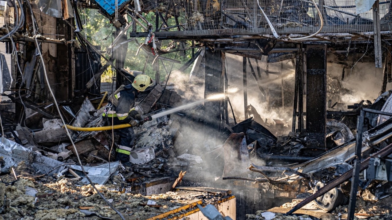 A firefighter works at the site of a drone strike. (Reuters)