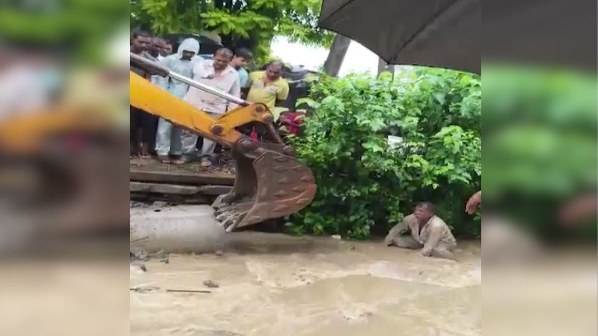 Man sitting in drain