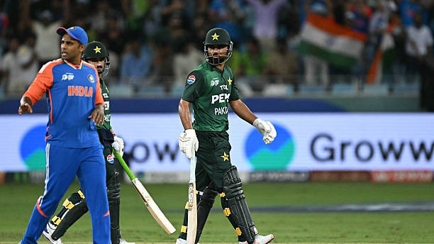 Pakistan's Fakhar Zaman (C) walks back to the pavilion