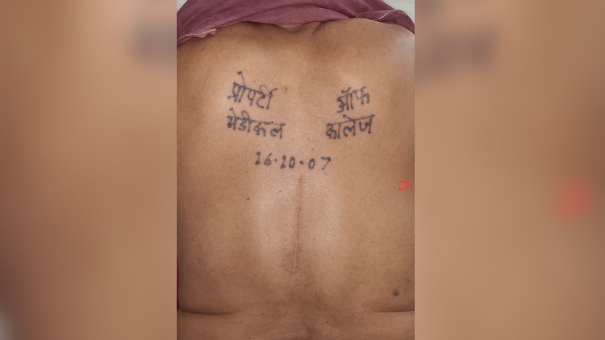 man showing back tattoo