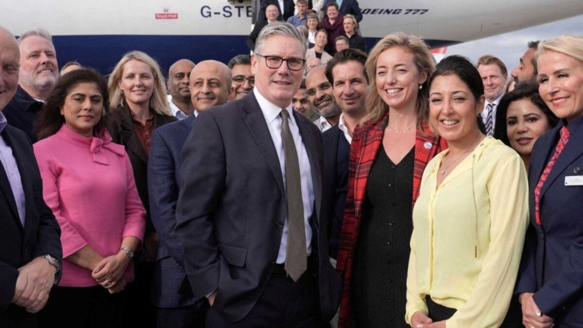 Keir Starmer stands with his business delegation before departing London