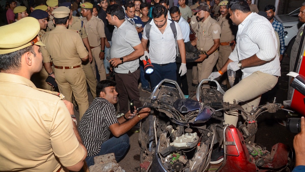 Kanpur: Police personnel and forensic experts investigate the spot after an explosion in Mishri Bazar area (PTI Photo