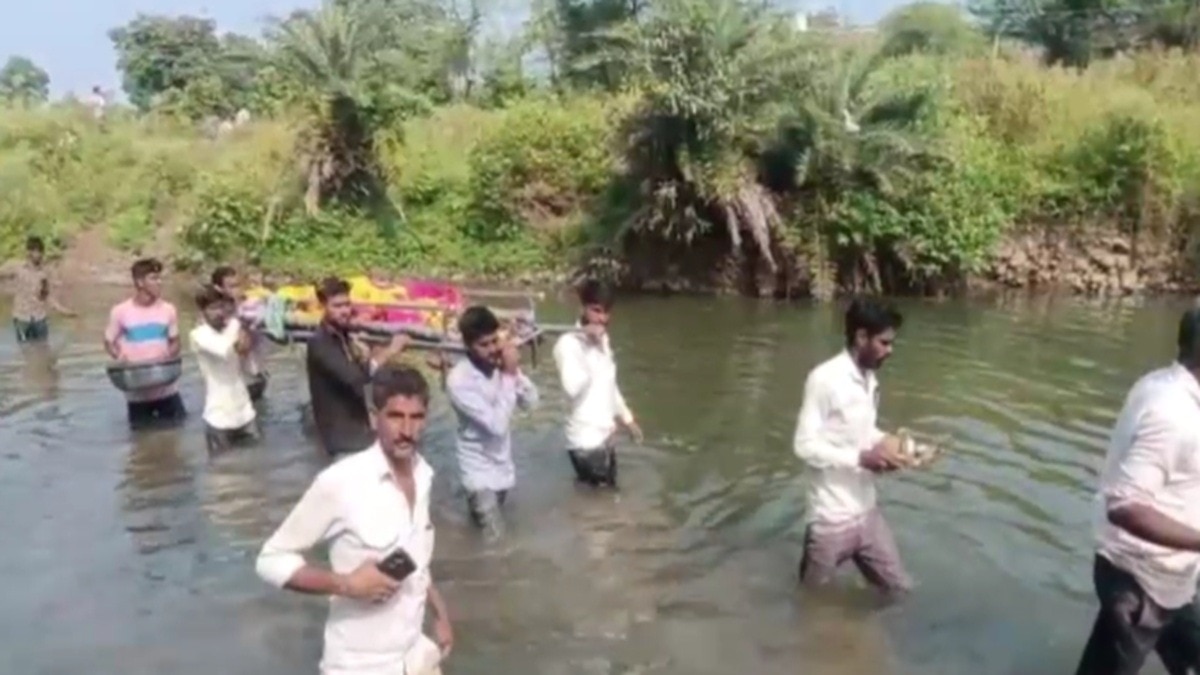 Men taking dead body through river 