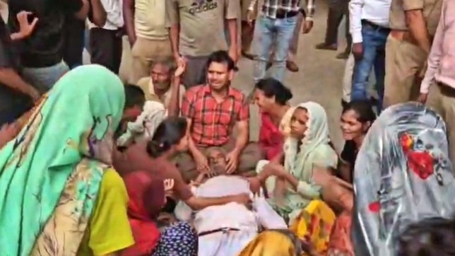 Family members weeping after the murder of former head in Etah (Photo- ITG)