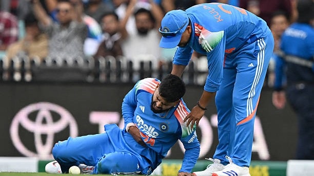 India's Shreyas Iyer (L) reacts in pain